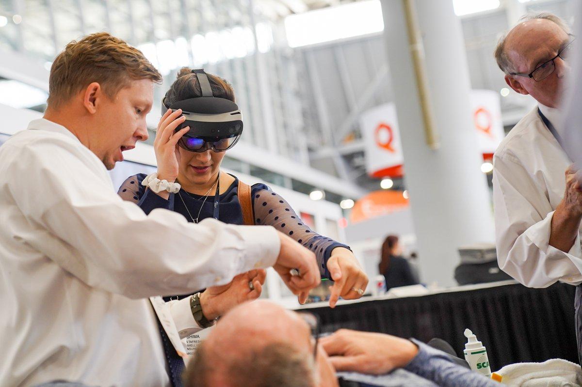 Clinicians demonstrating augmented reality navigation during an interventional radiology procedure at SIR